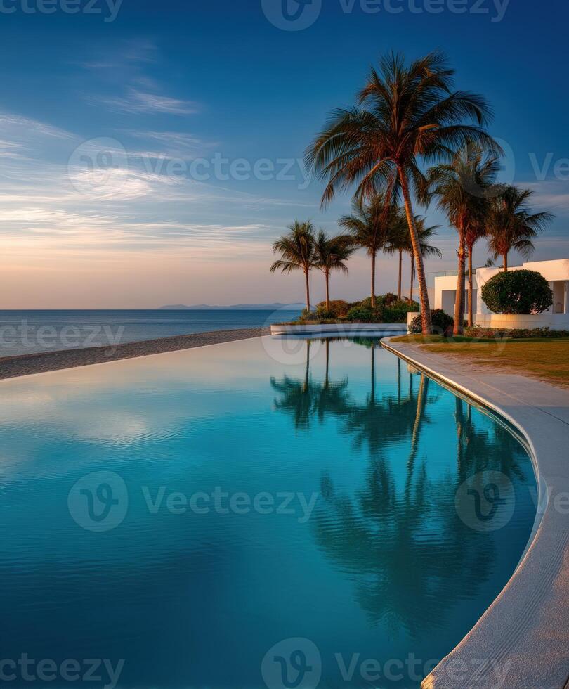 Serene sunset view over tranquil poolside landscape with palm trees photo