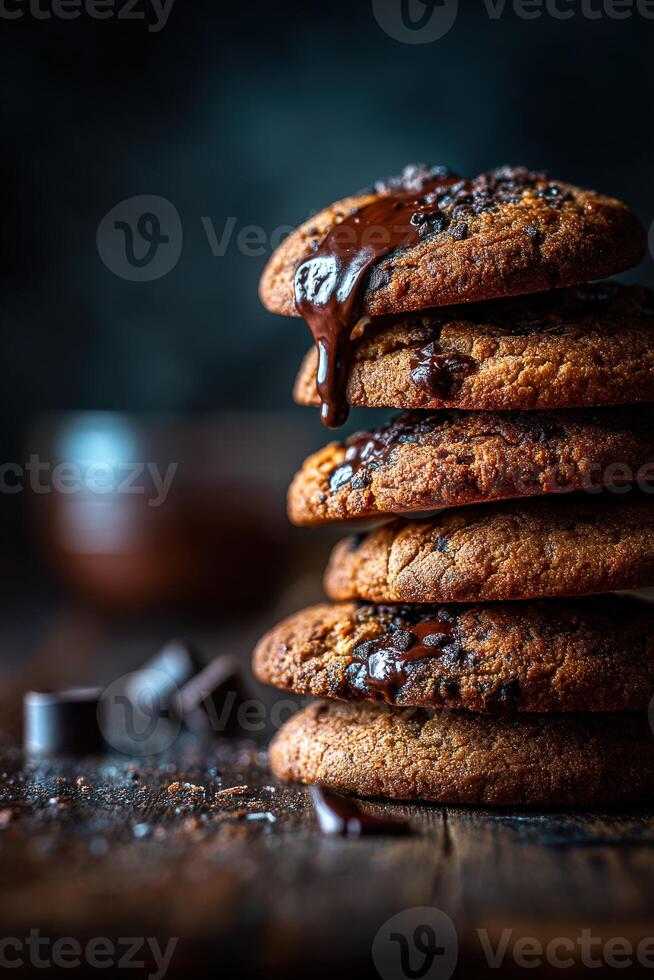 Warm chocolate chip cookies stacked high with melted chocolate dripping photo