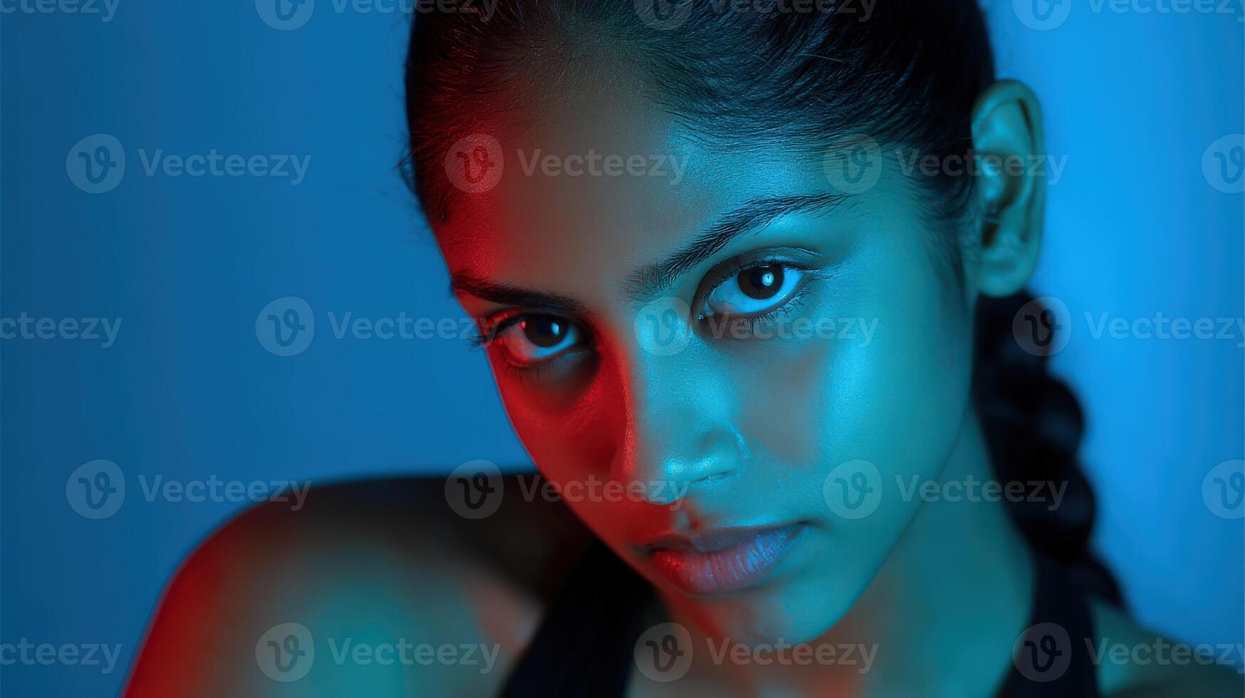 Captivating portrait of a young person with blue and red lighting photo