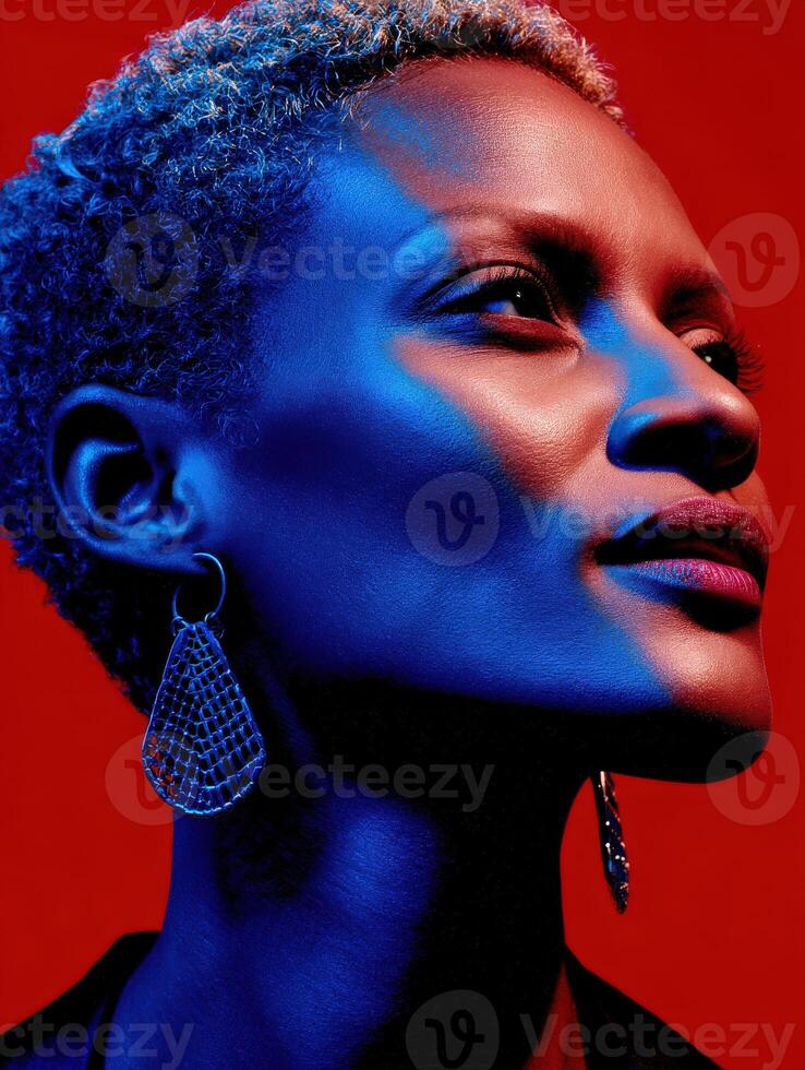 Woman with short hair and bold earrings against a vibrant background photo