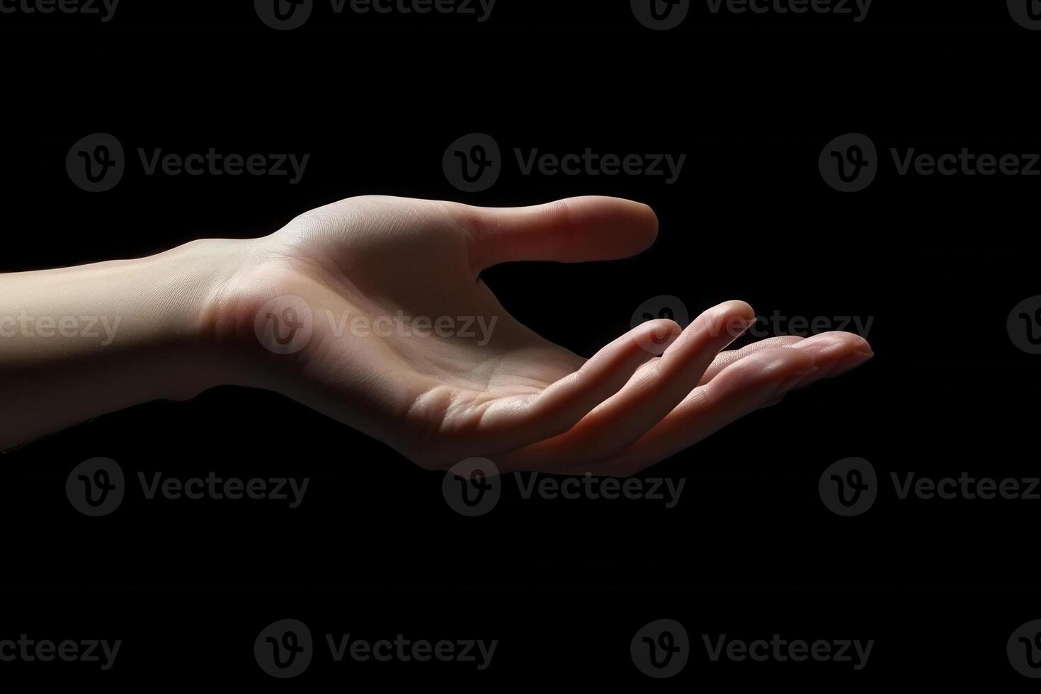 A close-up of an open human hand reaching out against a dark background, symbolizing connection photo