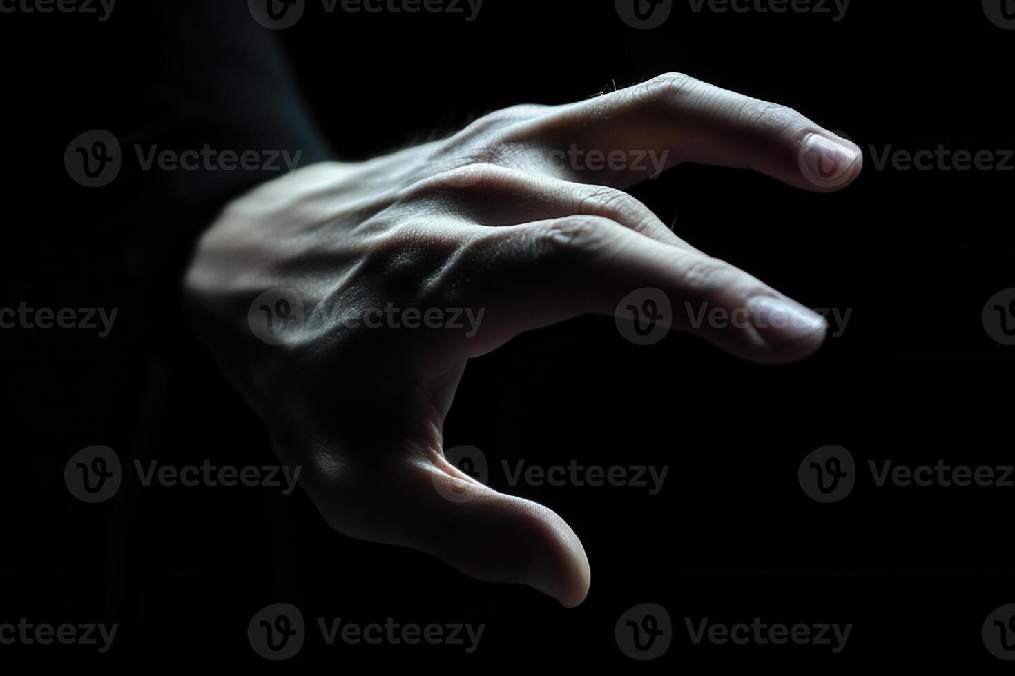 A close-up of a human hand reaching out against a dark background, evoking mystery and intrigue photo