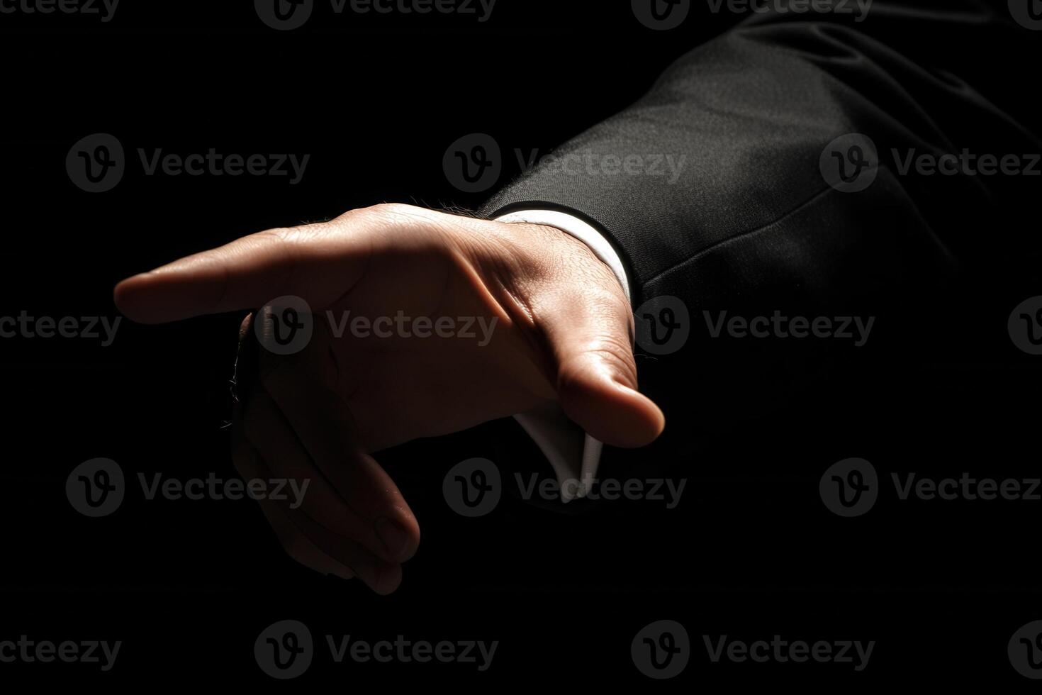 Elegant hand gesture in a dark setting, suggesting invitation or direction with style photo