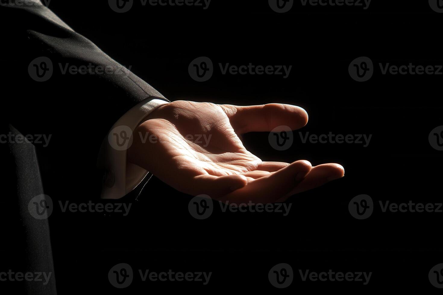 Elegant outstretched hand in a dark setting, symbolizing invitation or offering support photo