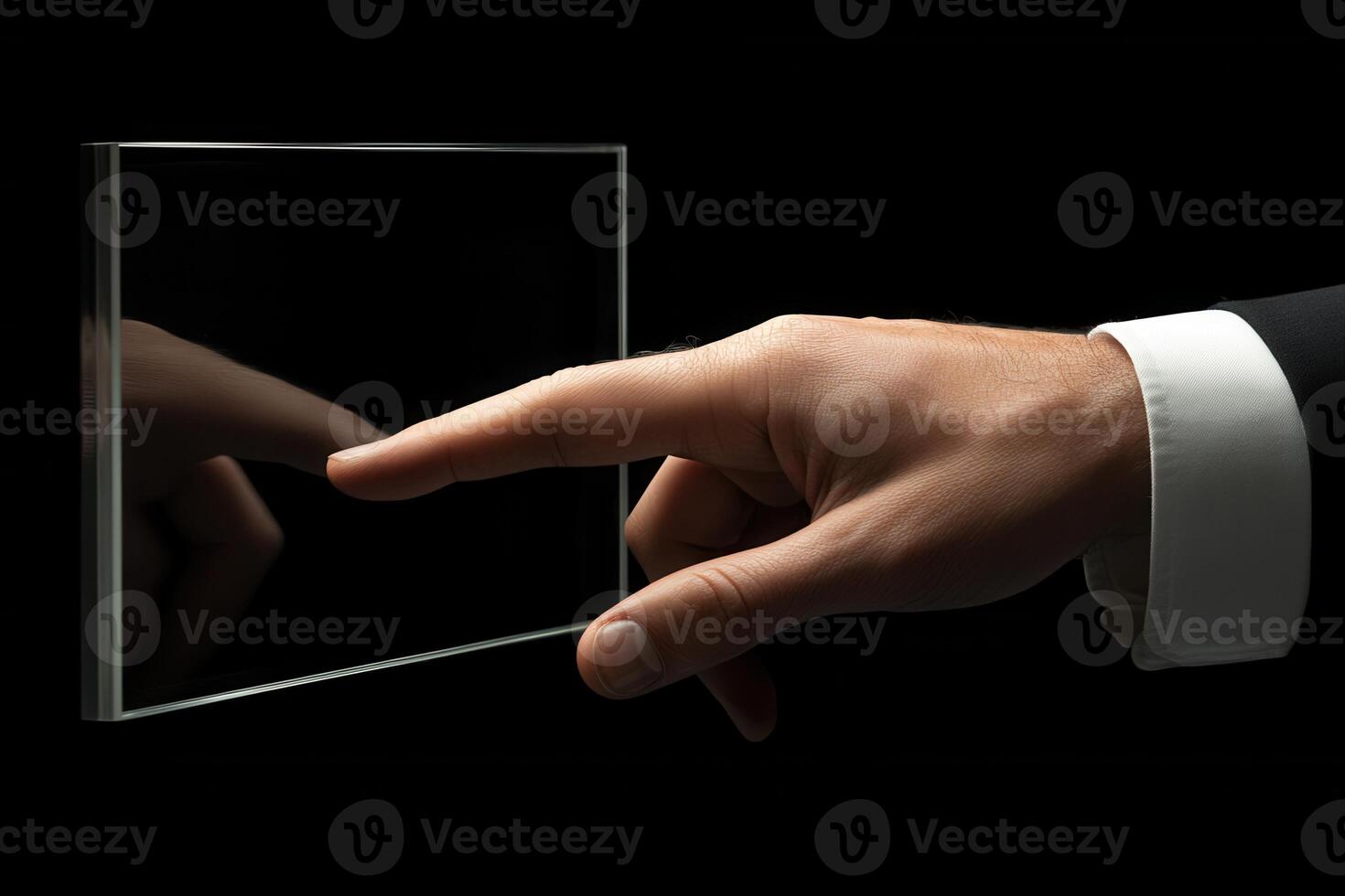 Elegant hand reaching towards a transparent glass panel in a dark environment, symbolizing innovation photo