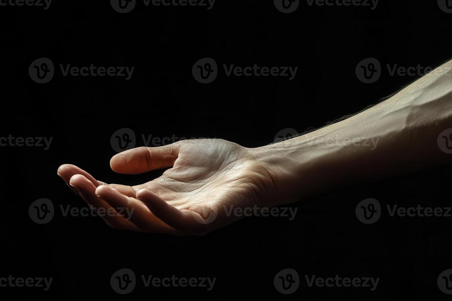 A close-up of an outstretched hand against a dark background, symbolizing openness and connection photo