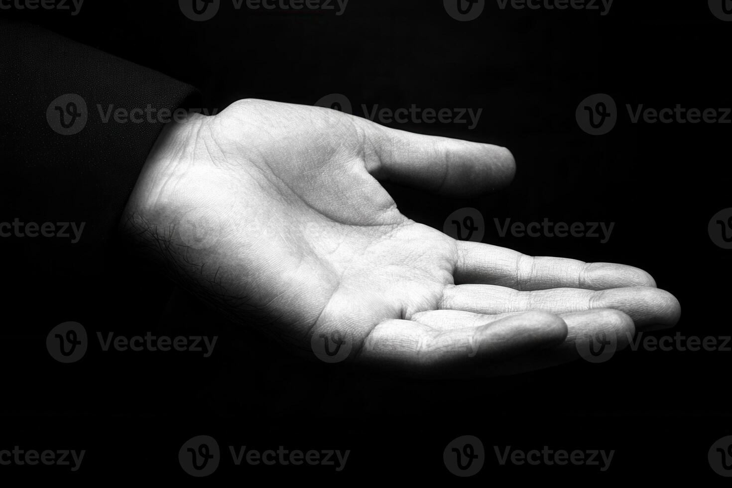 A close-up of an open hand against a dark background, symbolizing offering or waiting photo