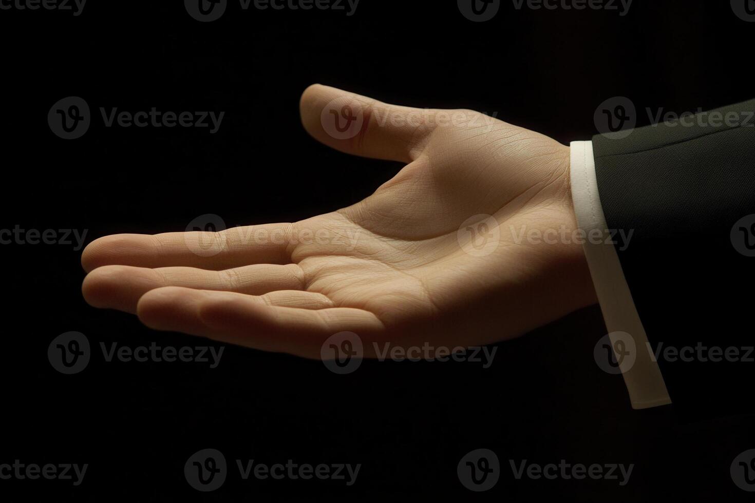 Elegant open hand gesture in dim lighting, suggesting invitation or offering, with subtle shadows photo