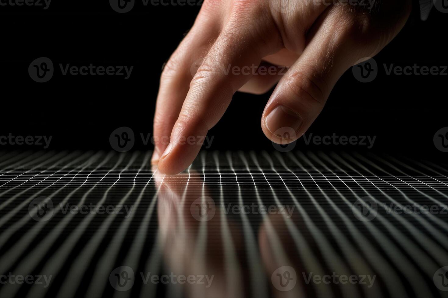 A close-up of a hand gently touching a reflective surface with linear patterns, creating ripples photo