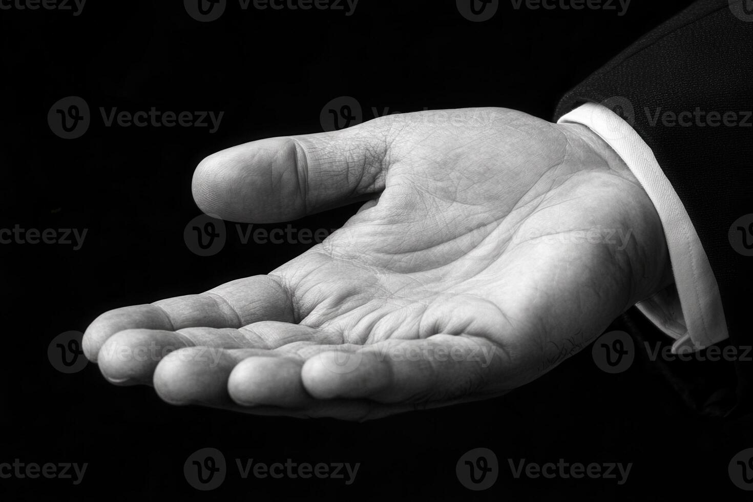 Elegant black and white image of an open hand, symbolizing invitation or assistance photo