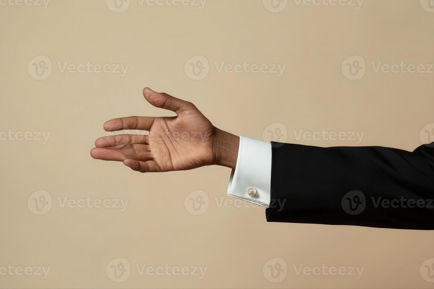 Elegant hand gesture in a formal suit against a neutral background, conveying invitation photo