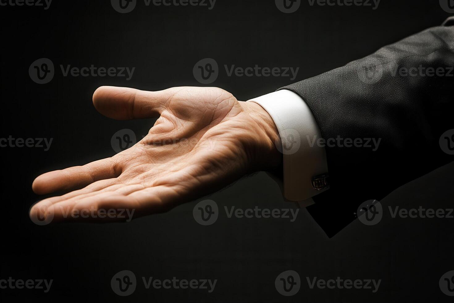 Elegant hand gesture in a formal suit against a dark background, inviting interaction photo
