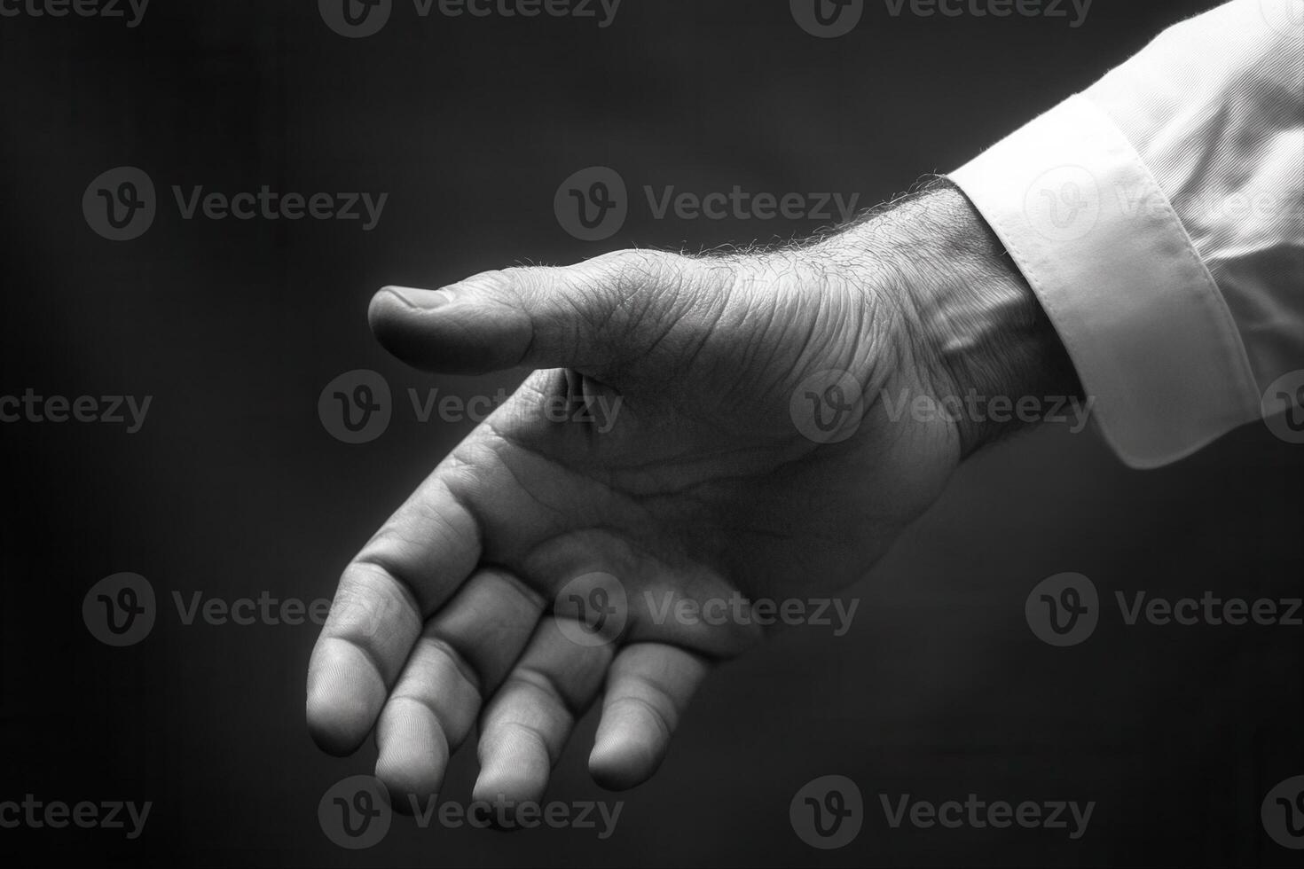 A close-up of an outstretched hand in black and white, symbolizing invitation and connection photo