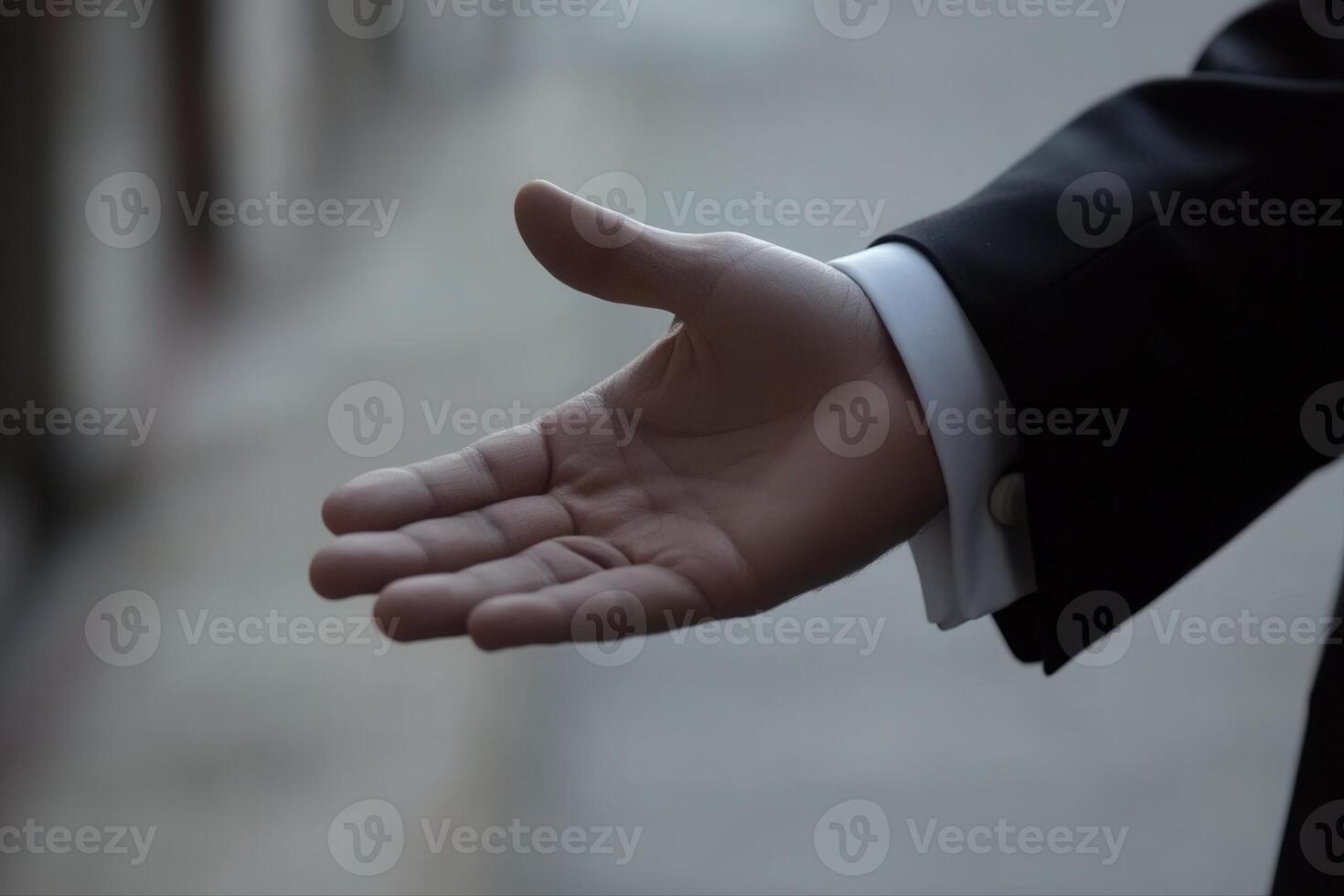 Elegant hand reaching out in a formal setting, blurred background suggests anticipation photo