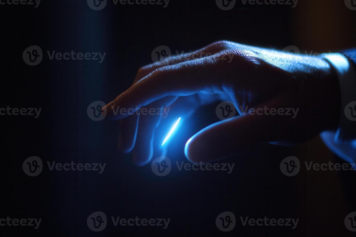 Close-up of a human hand reaching towards a glowing light source in a dark environment photo
