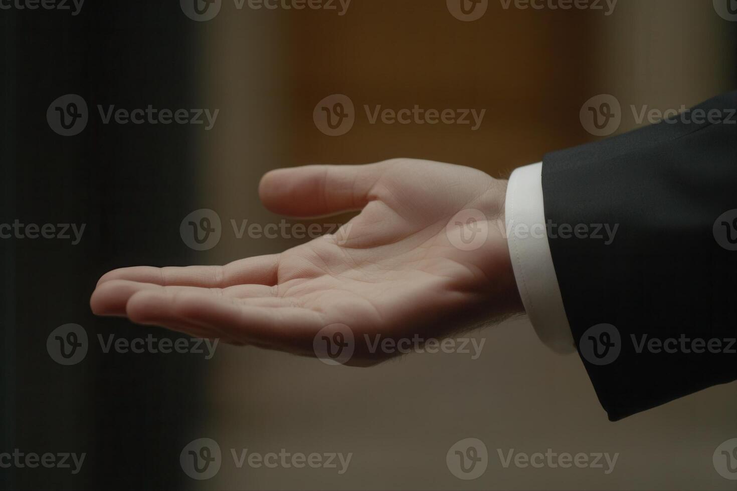 Elegant hand gesture of a businessman in formal attire, showcasing professionalism indoors photo