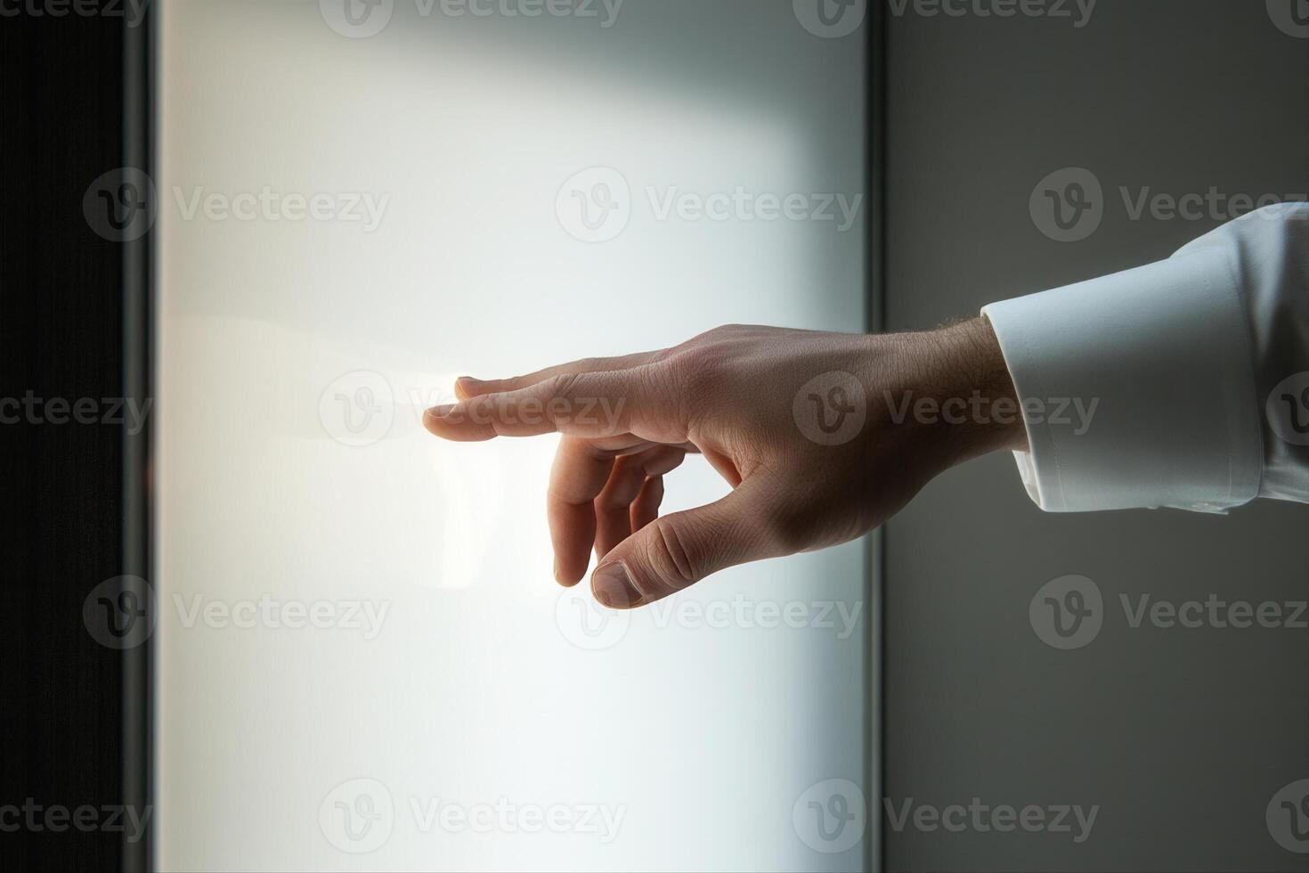 A hand reaching towards a glowing surface, symbolizing connection and innovation in a modern setting photo
