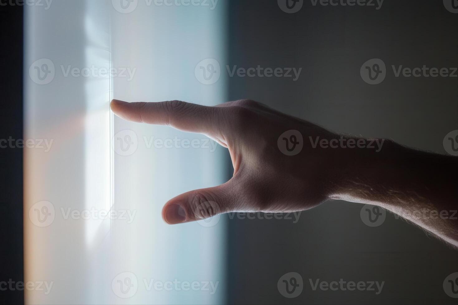 A hand reaching towards a glowing screen, exploring digital interaction in a modern setting photo