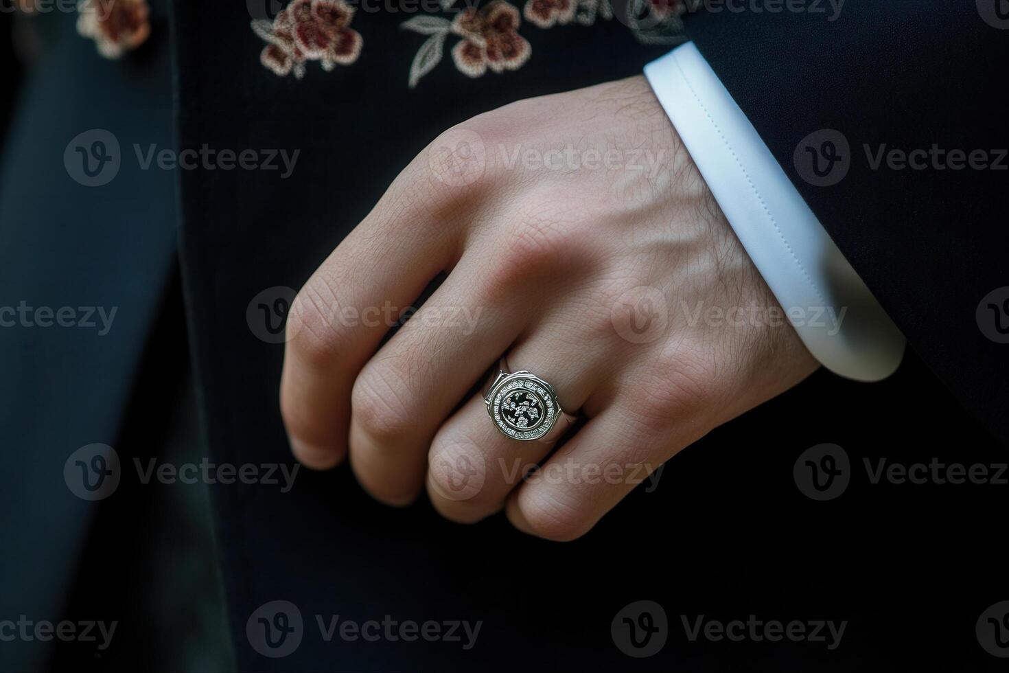 Elegant close-up of a man's hand wearing a stylish ring, showcasing intricate details photo
