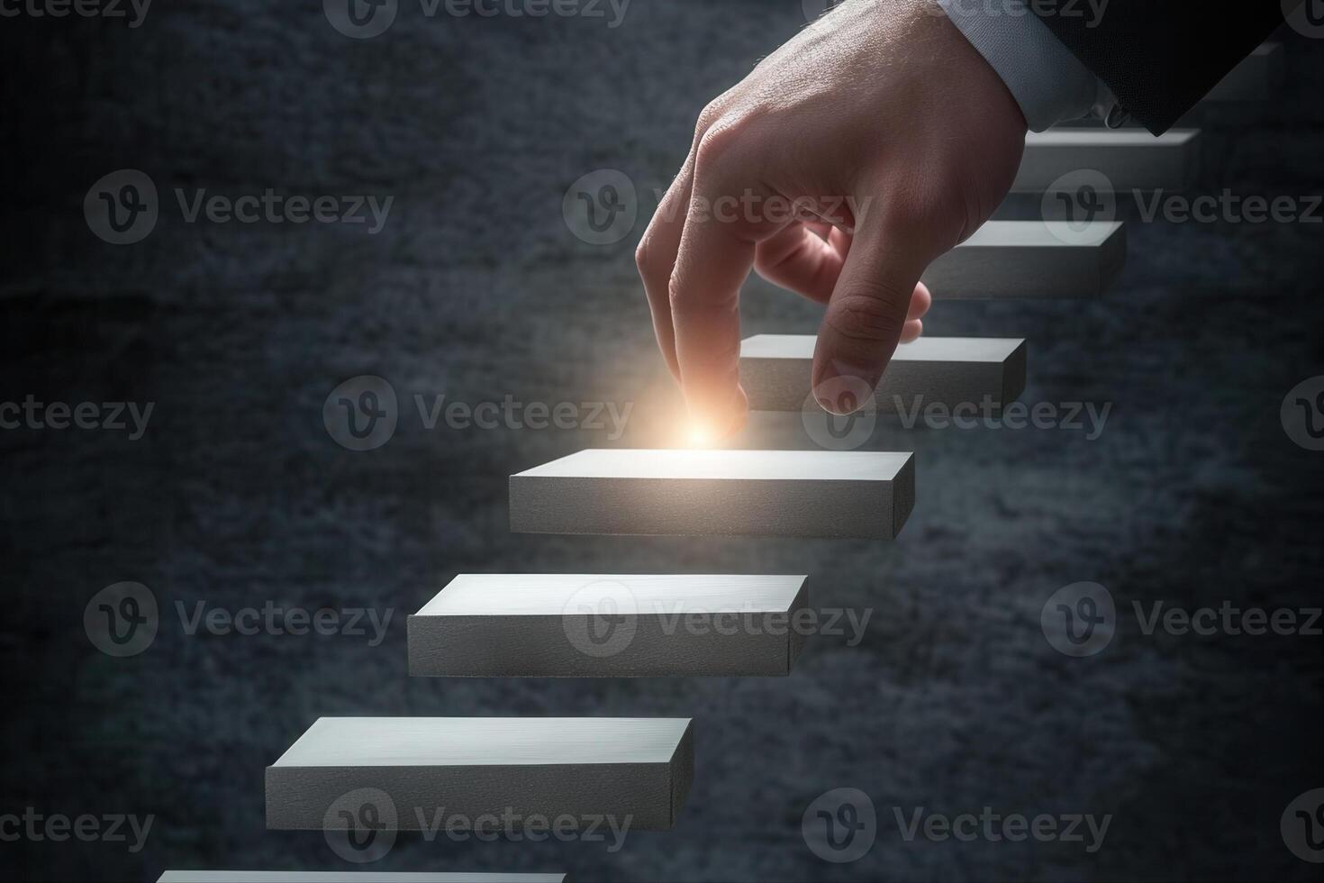 A hand reaching for a glowing step on a staircase, symbolizing progress and ambition photo