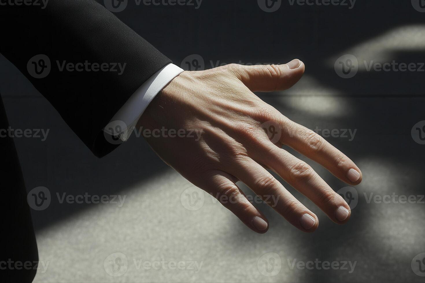Elegant business hand gesture extending towards the viewer against a softly lit background photo