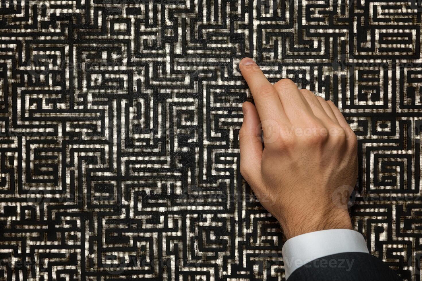 A businessman navigating a complex maze pattern with his finger, symbolizing problem-solving photo