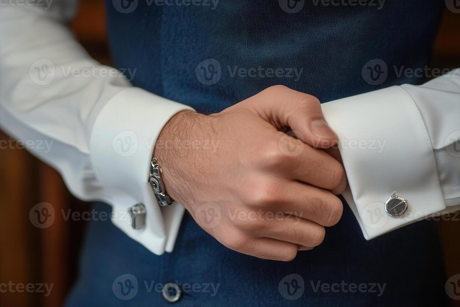 Elegant man adjusting cufflinks on his formal shirt in a sophisticated indoor setting photo
