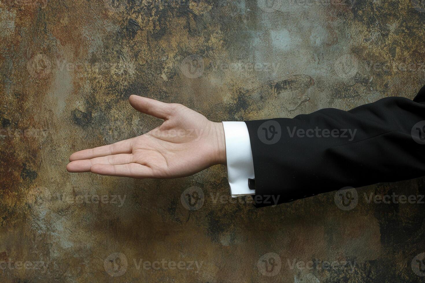 Elegant hand gesture in formal attire against a textured background, suggesting invitation photo