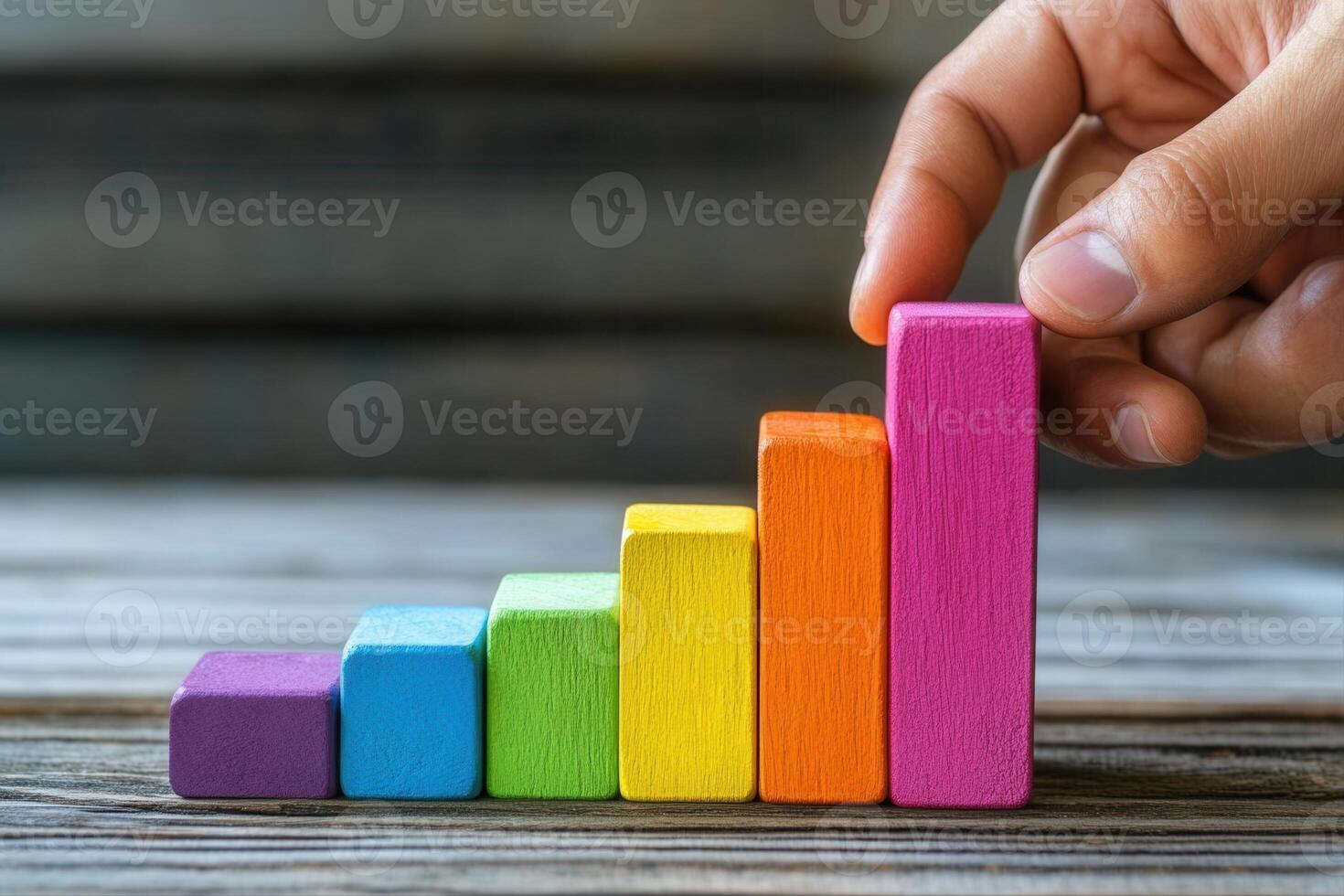 Colorful wooden blocks arranged in ascending order, symbolizing growth on a rustic table photo