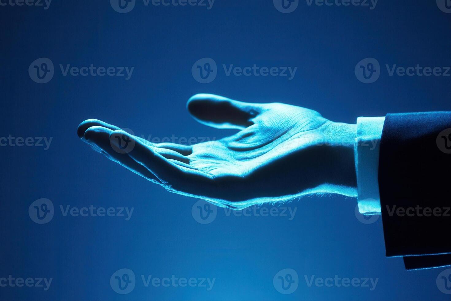 Elegant hand gesture in a business suit against a blue background, symbolizing opportunity photo