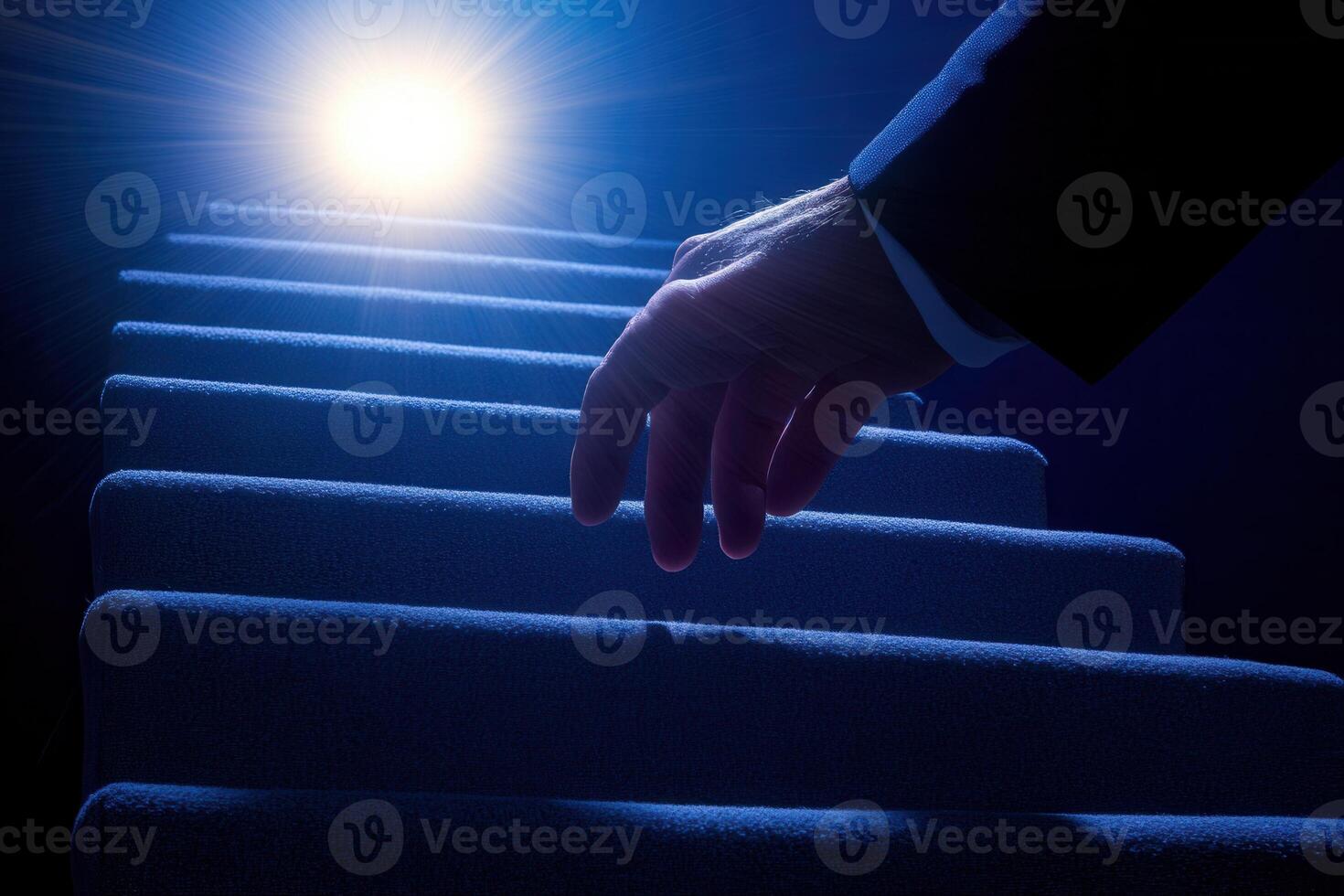 A hand reaching towards a bright light at the top of a dark staircase, symbolizing hope photo