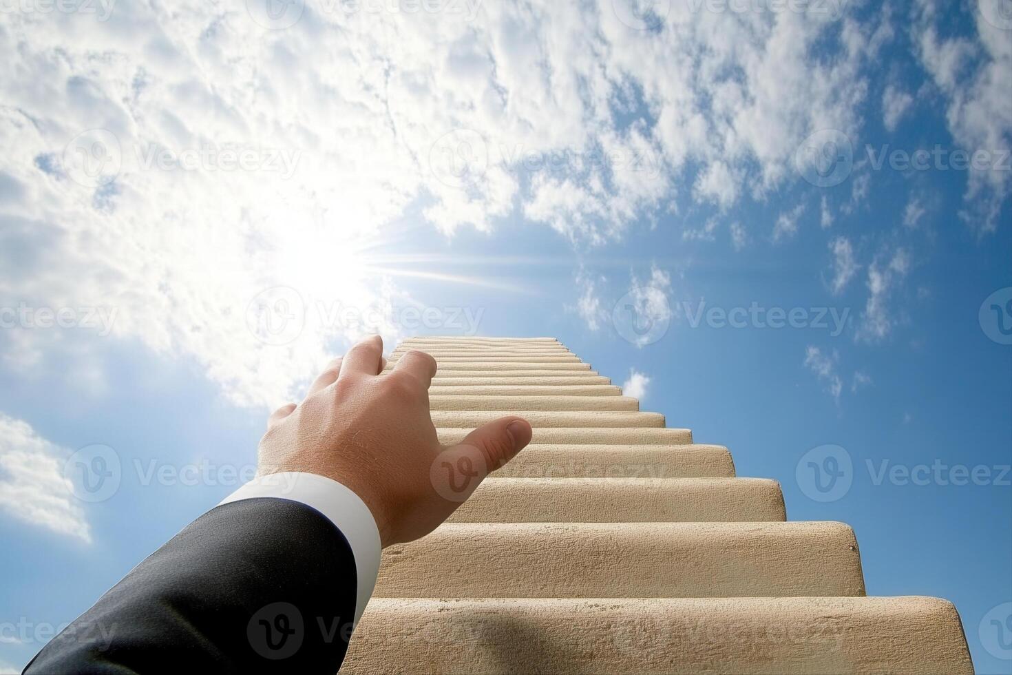 A business professional reaching for success while climbing a stairway to the clouds photo