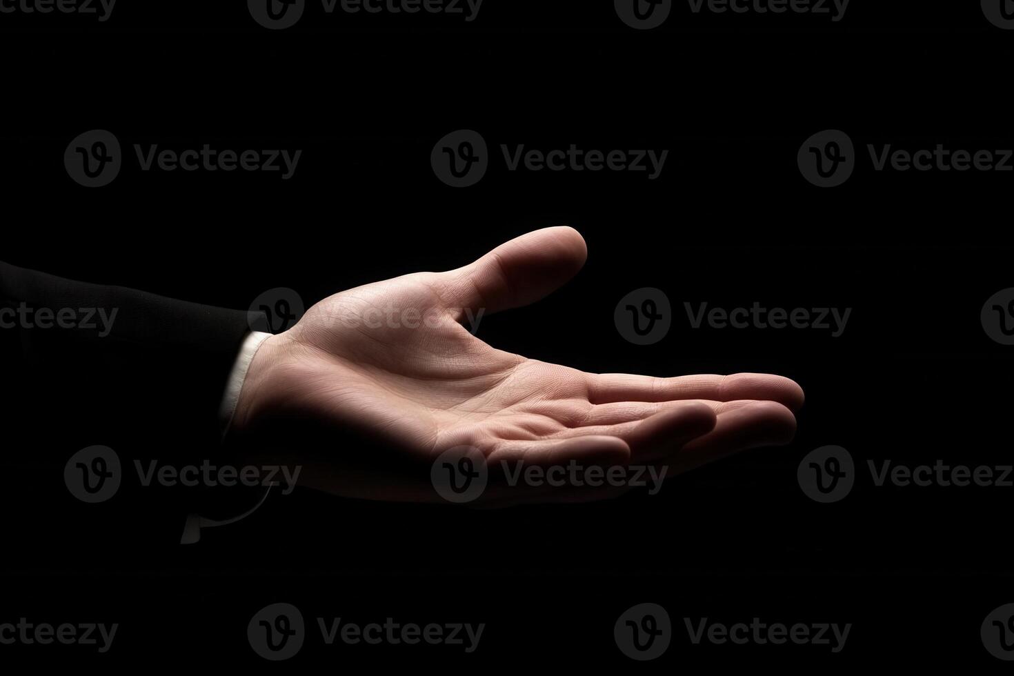 Open hand gesture in a dark setting, symbolizing invitation or assistance photo