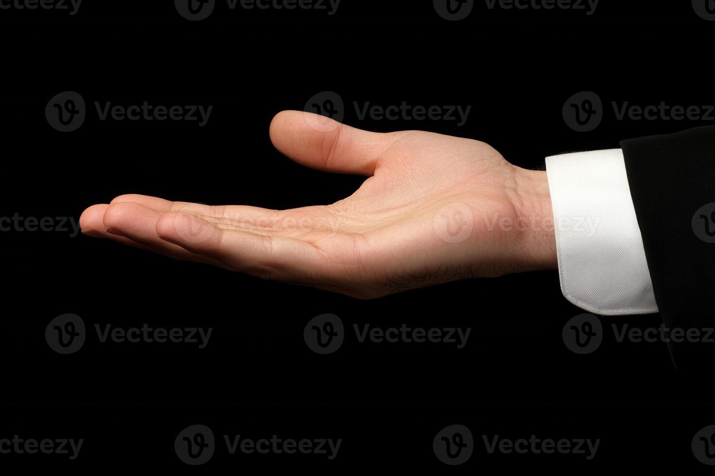 Open hand gesture against a black background, symbolizing invitation or offering photo