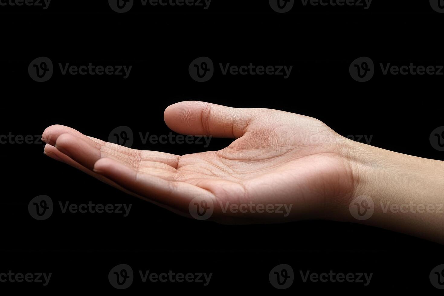 Open hand gesture against a black background, symbolizing offering or waiting for help photo