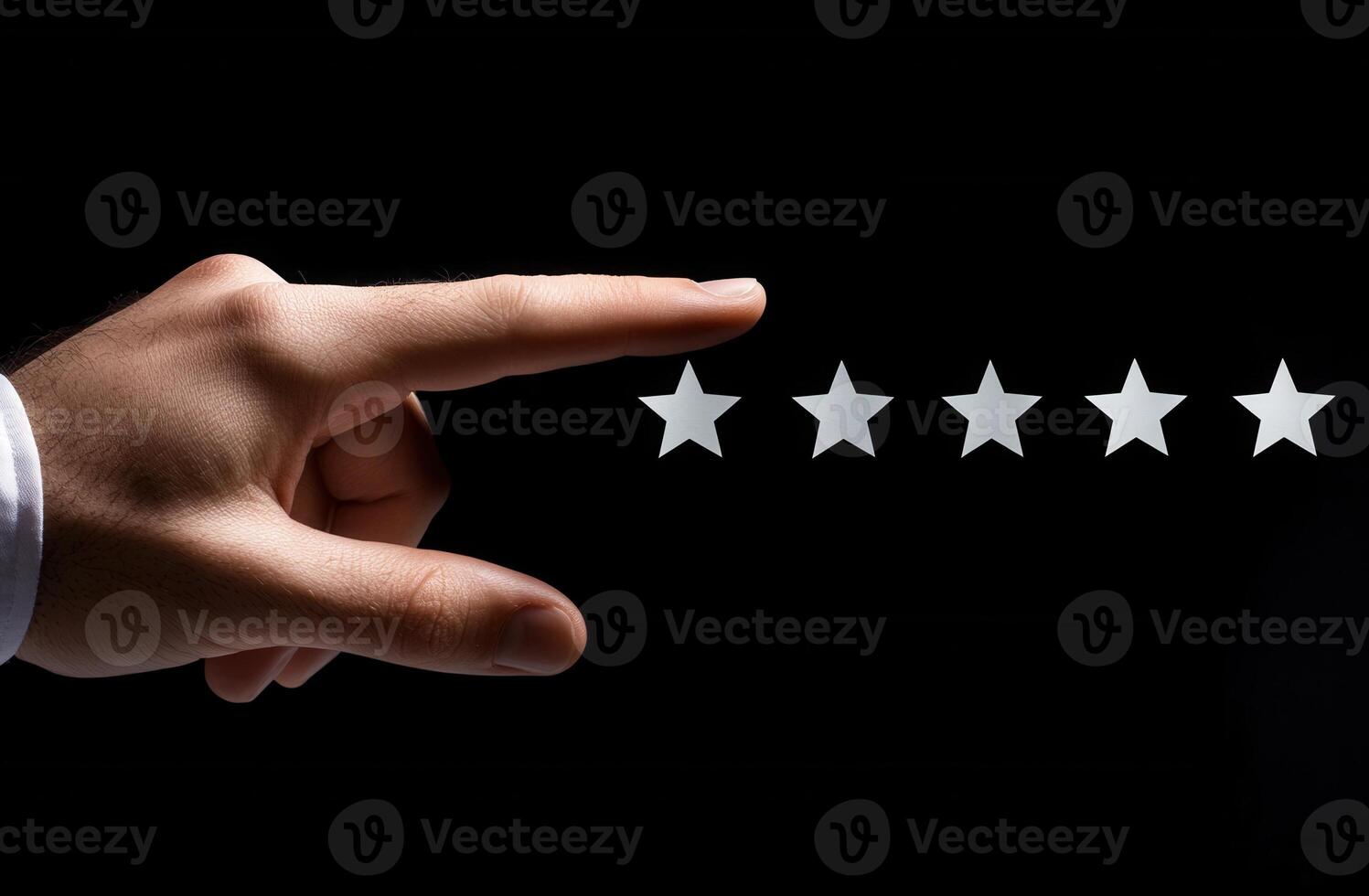 Hand reaching toward five empty stars on a black background, symbolizing rating or review photo