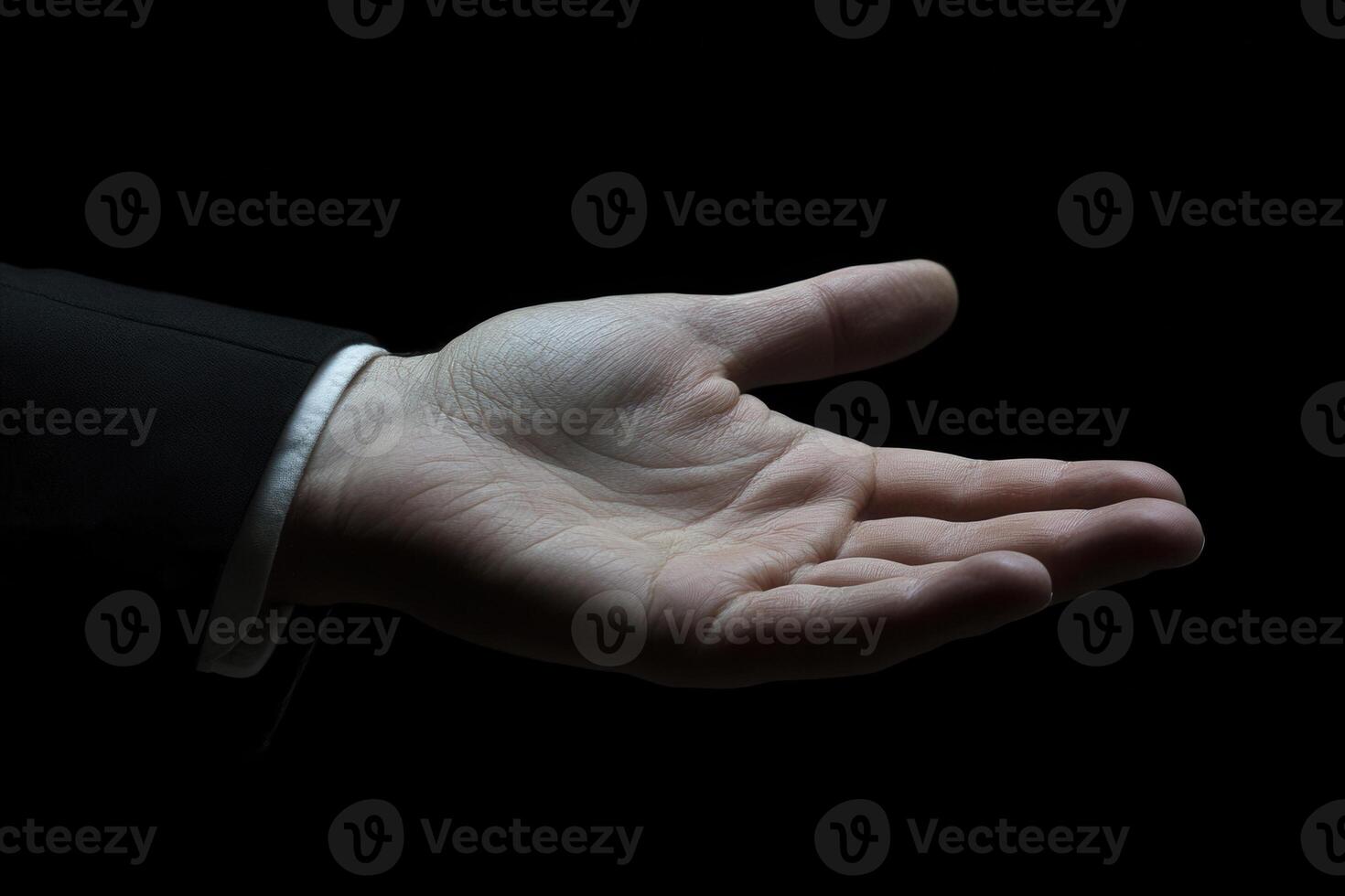 Open hand gesture in a dark setting, symbolizing invitation or offering, with subtle elegance photo