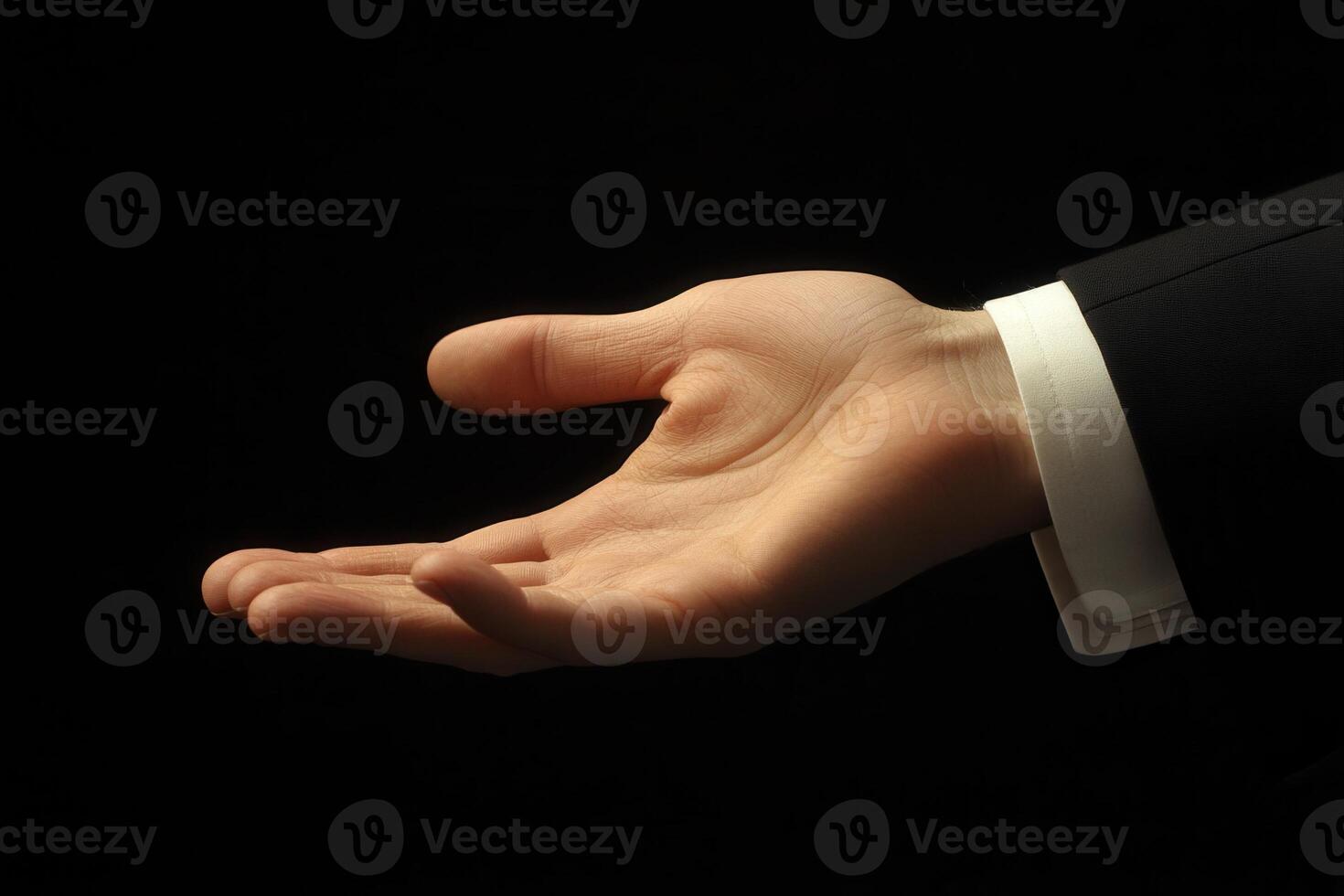 Elegant outstretched hand in a formal suit against a dark background, symbolizing invitation photo