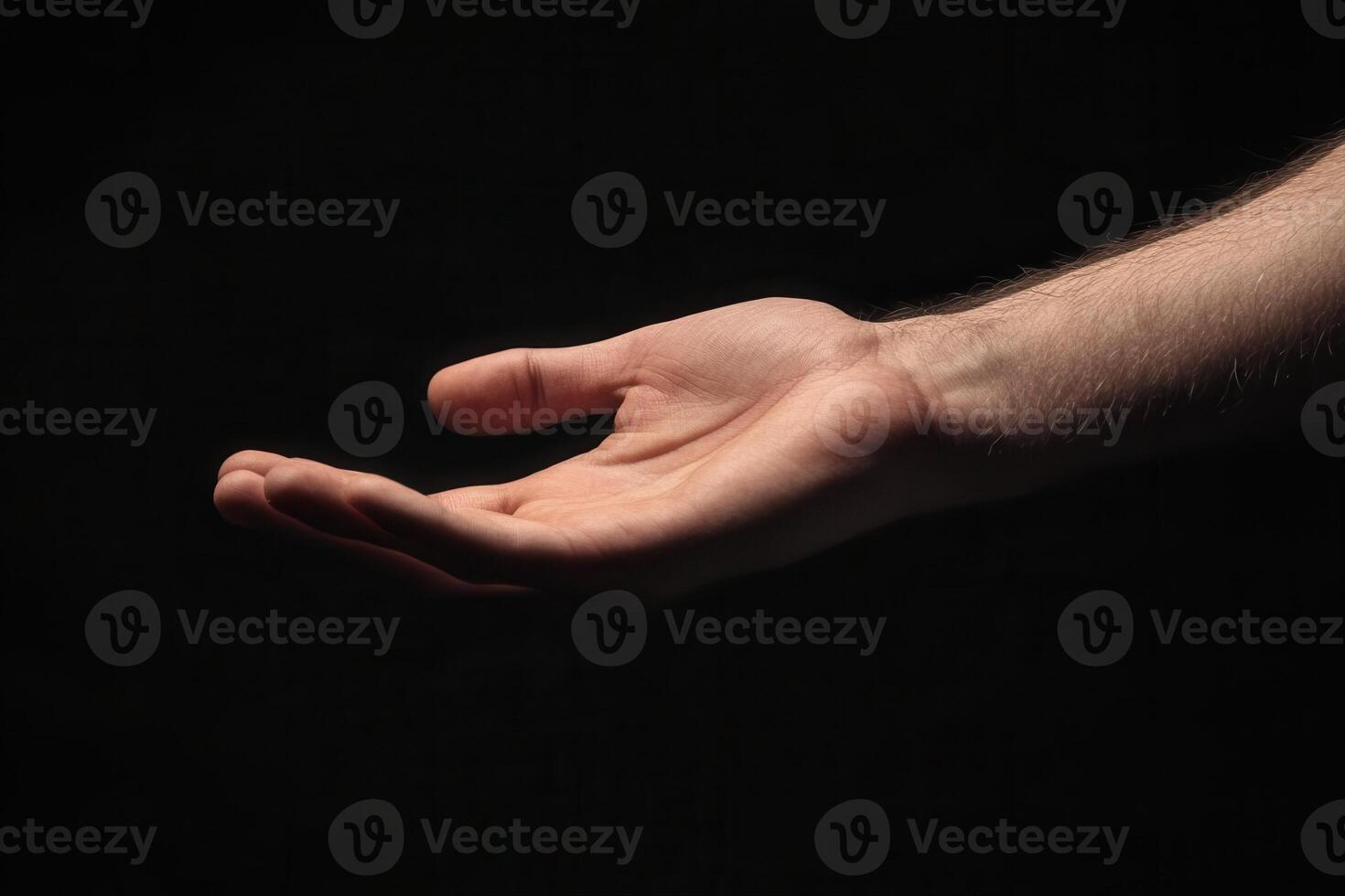Outstretched hand against a dark background, symbolizing openness and invitation photo