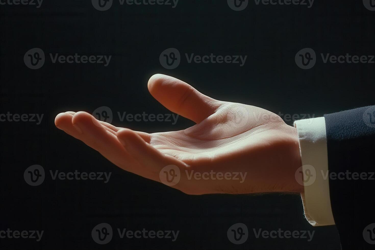 Elegant outstretched hand in a suit against a dark background, symbolizing opportunity photo