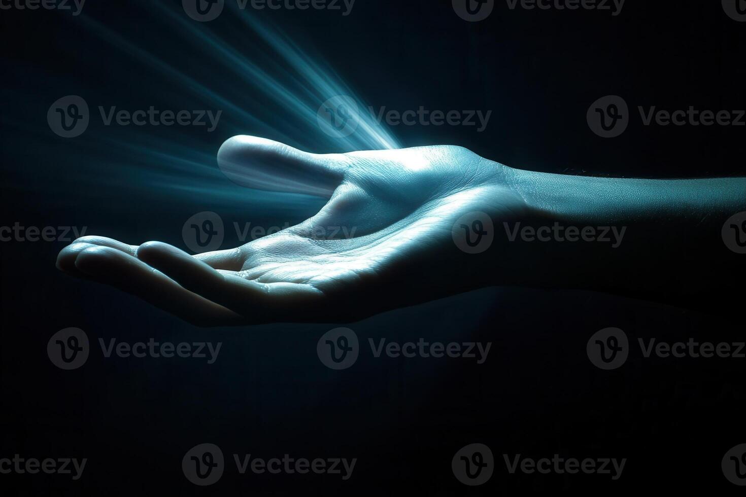Illuminated hand reaching out in darkness, symbolizing hope and connection with soft light photo