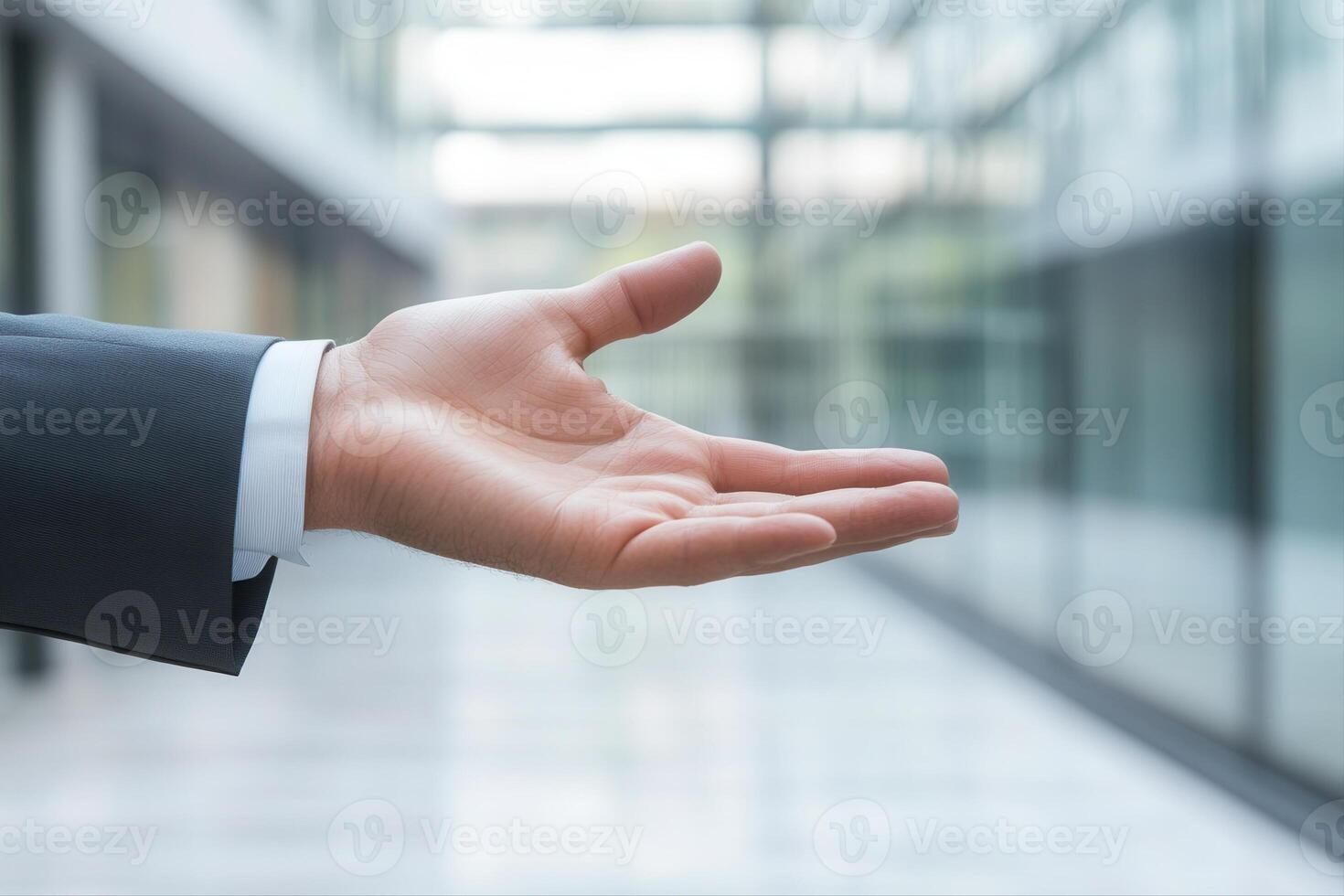 Open hand gesture in a modern office corridor, inviting collaboration and discussion photo