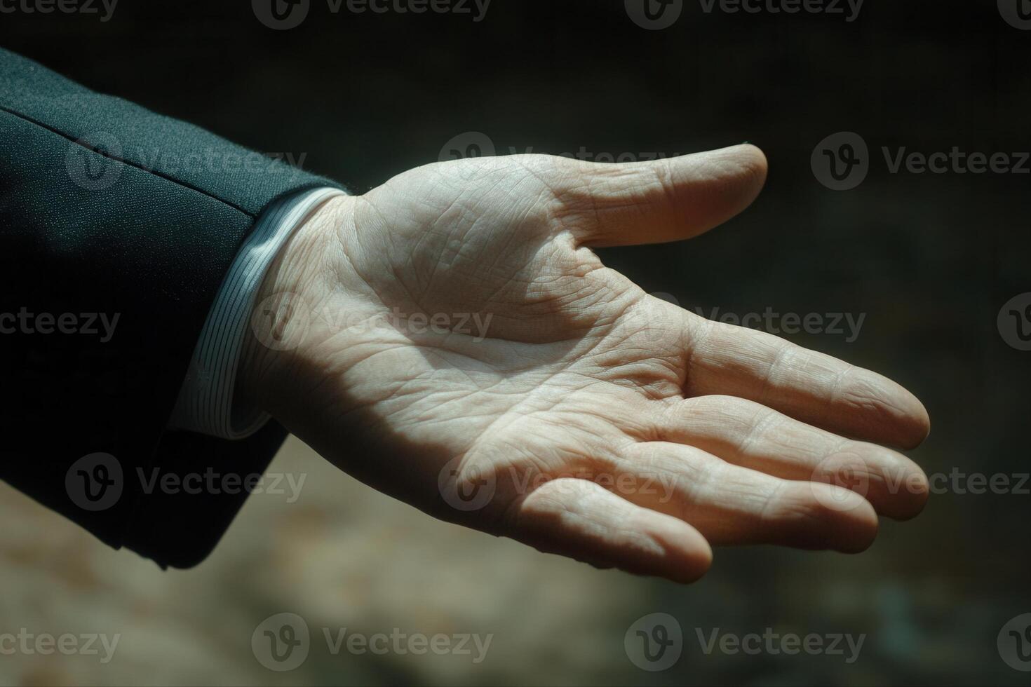 Outstretched hand in a formal setting, symbolizing greeting or offering assistance photo