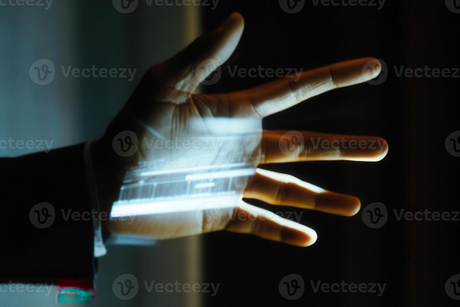 Illuminated hand displaying technology in a dark room, showcasing innovation and creativity photo