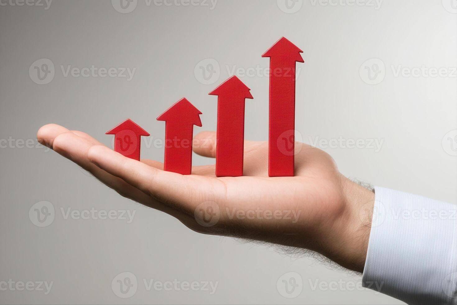 Hand holding red upward arrows representing growth and success in a minimalist setting photo