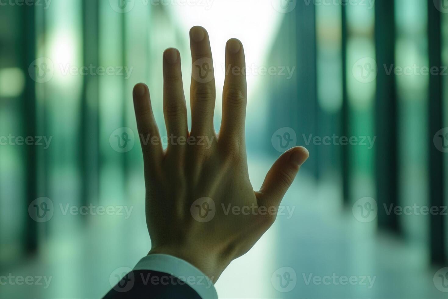 Hand reaching out in a modern office corridor, symbolizing connection and ambition photo