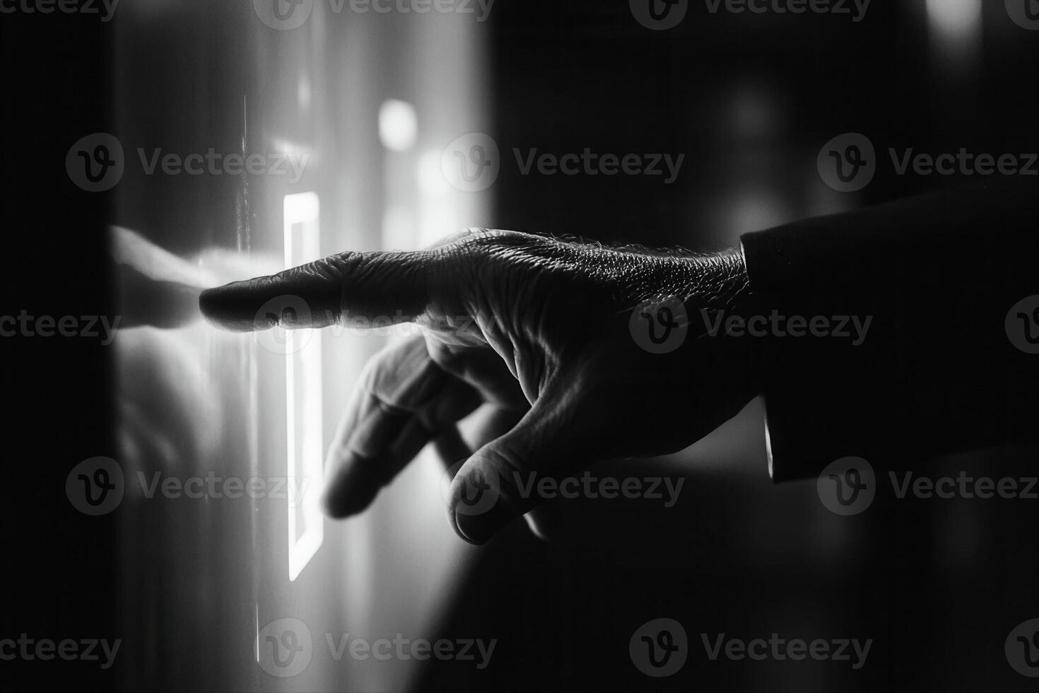 Hand pressing a glowing button on a sleek panel in a dimly lit modern environment photo
