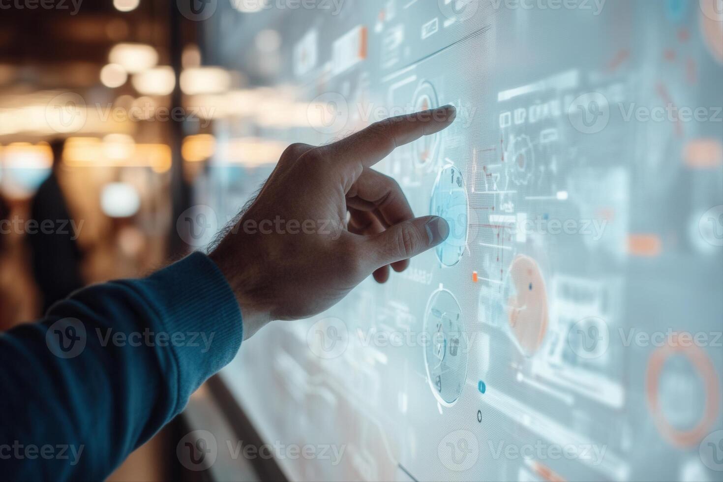 Person interacting with a digital touchscreen interface displaying data and analytics in a modern workspace photo