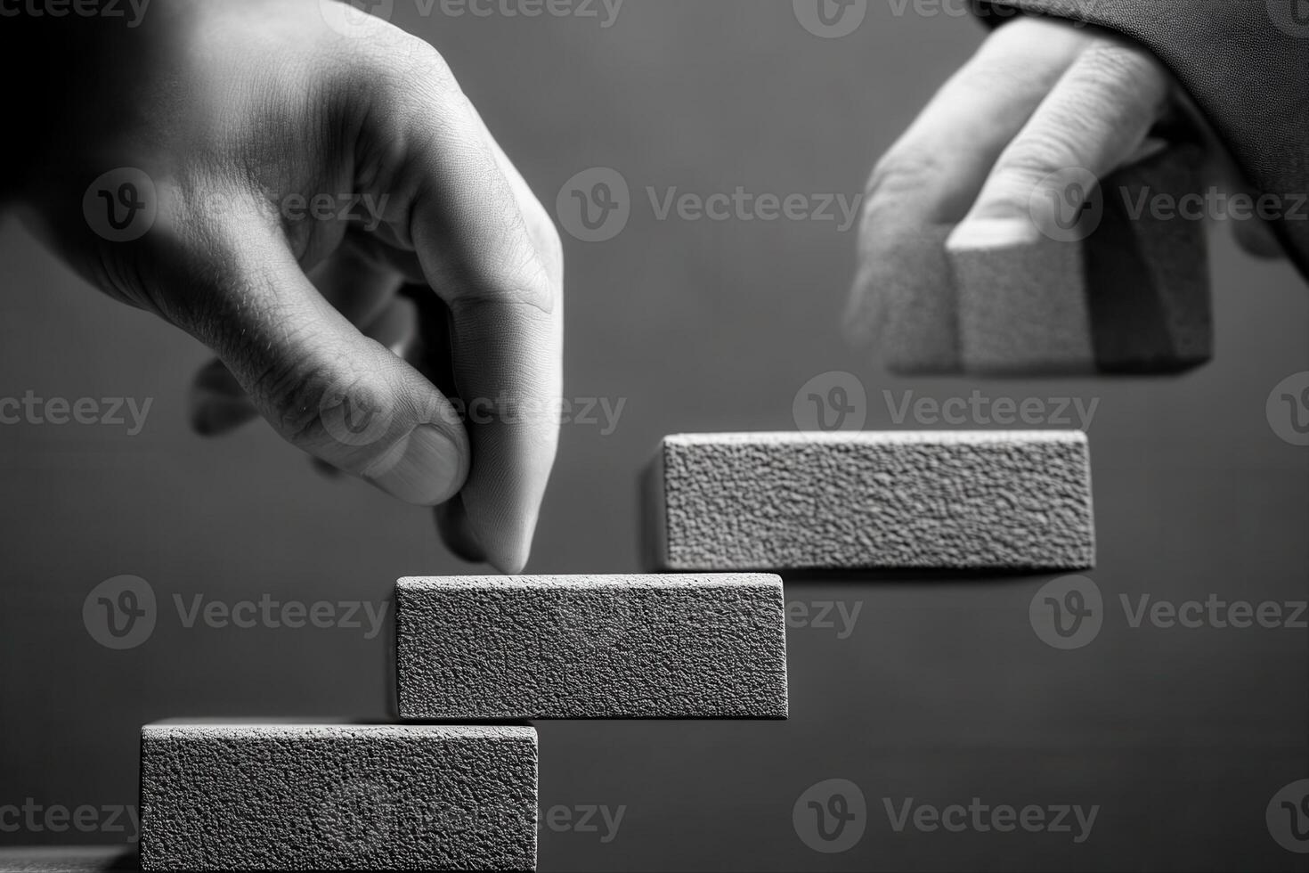 Two hands placing textured blocks on a staircase, symbolizing progress and teamwork photo