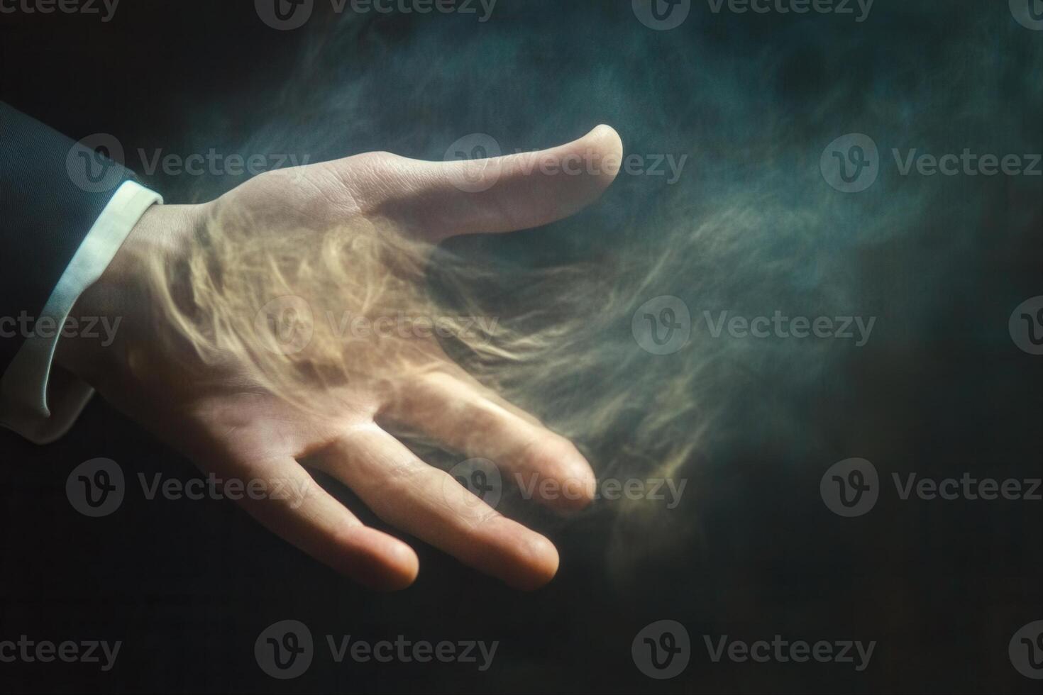 Mysterious hand emitting smoke in a dark setting, suggesting magic or transformation photo
